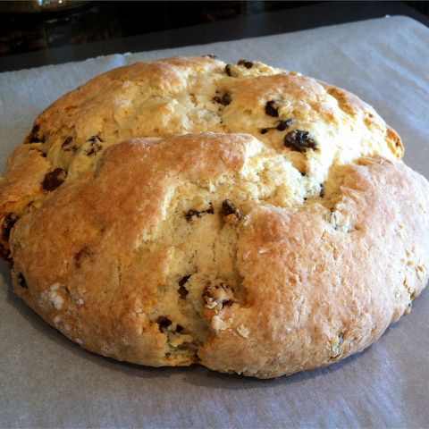 high angle looking at a large loaf of nana dot's Irish soda bread resting on parchment paper