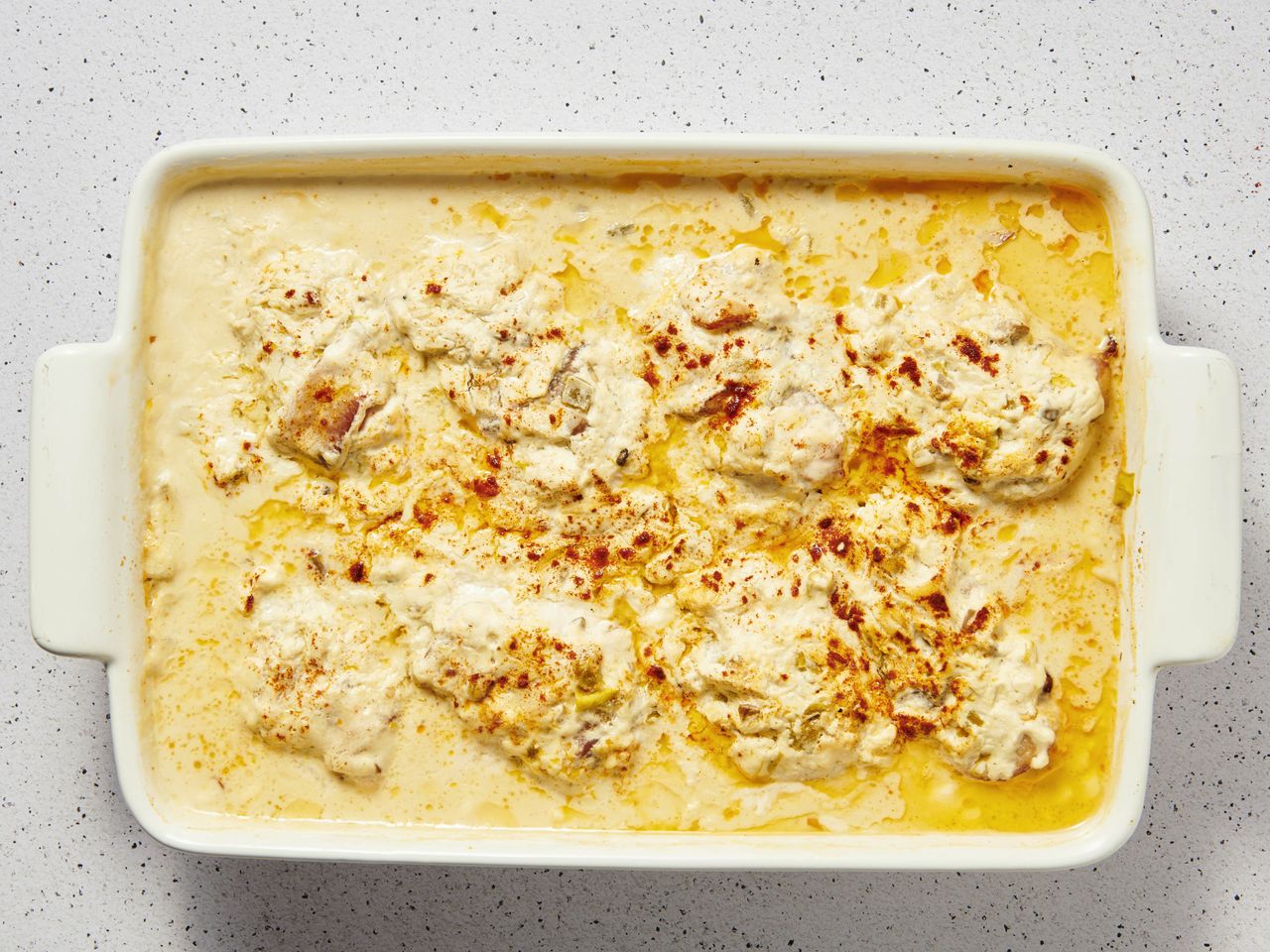 A baking dish of bacon-wrapped chicken breasts and dried beef in cream sauce