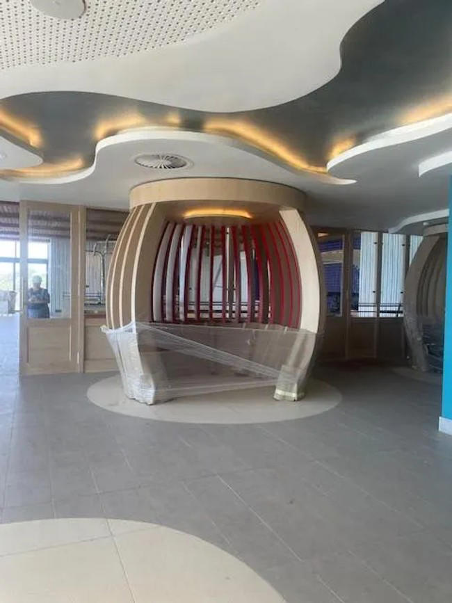 Unwrapping the whalebone pod that will be seating in the dining area.