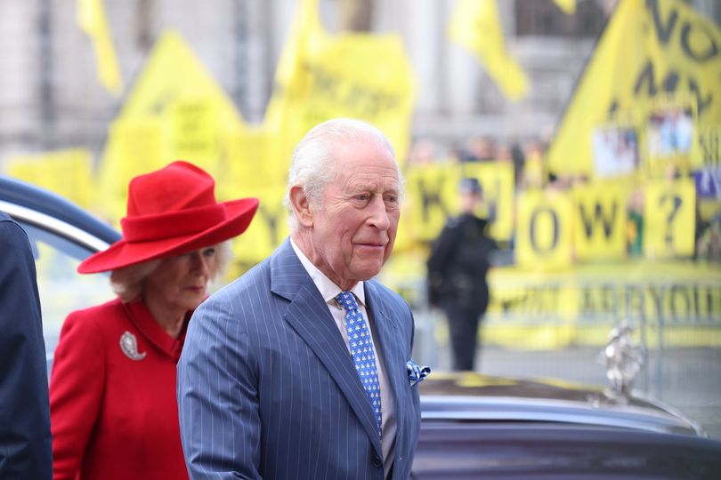 Charles and Camilla arrive for the service with protesters in the background