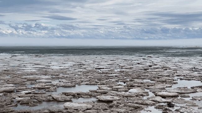 Broken ice lines shore of Lake Erie as thaw begins