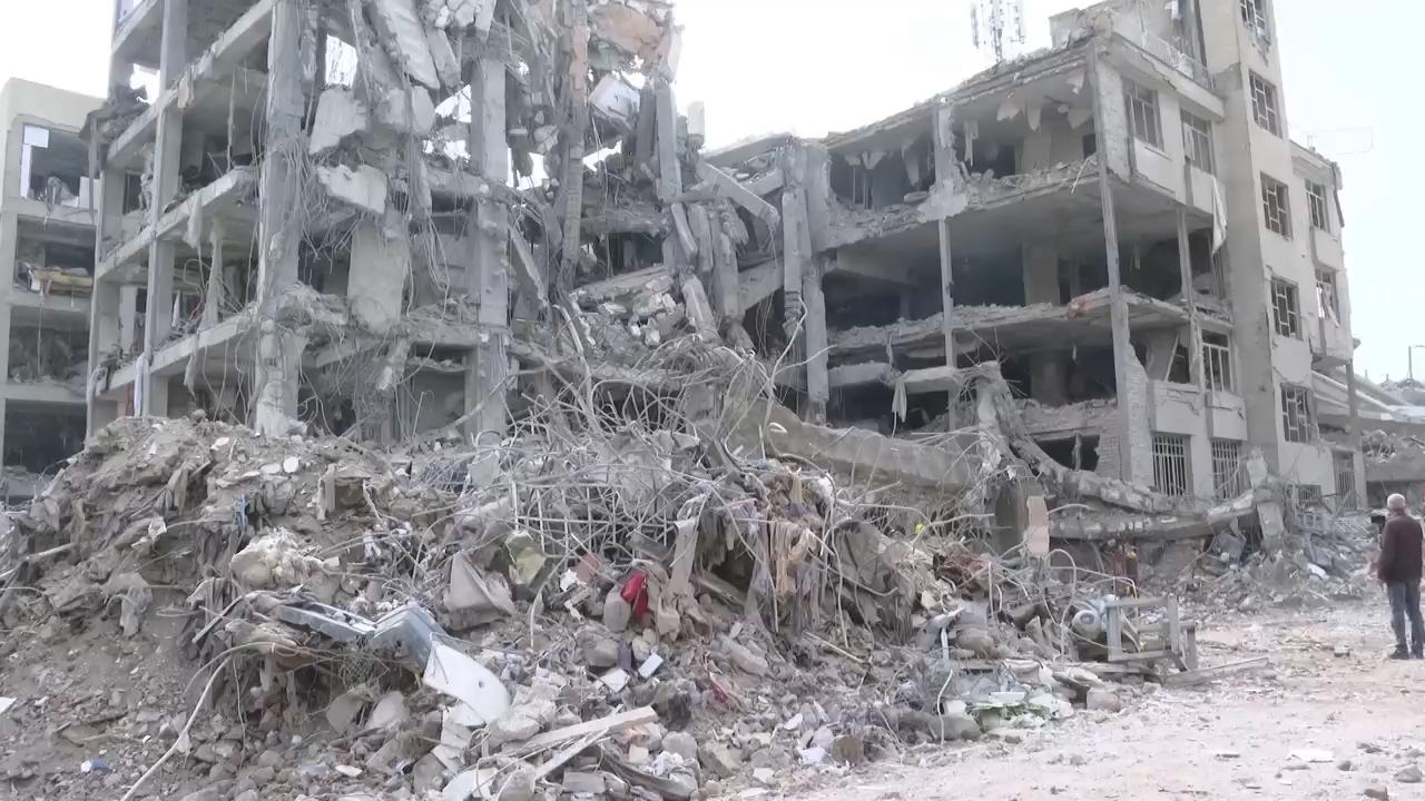 Workers in Tehran remove debris and rubble from buildings damaged by ...