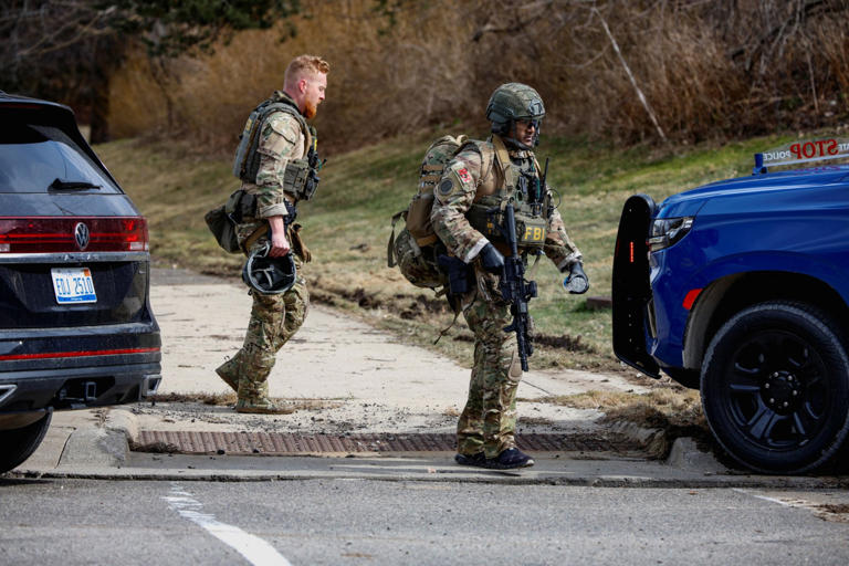 Badly burned gunman found dead after crashing car filled with ...