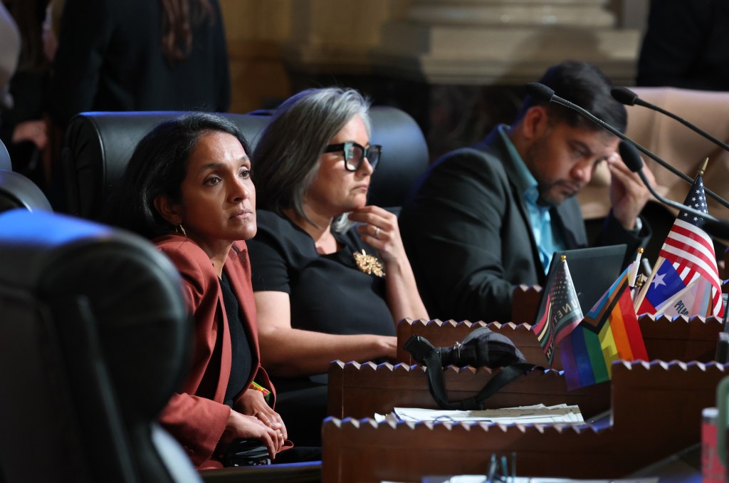 Los Angeles city council member listen to fellow members as they debate a plan to waive building permit fees for property owners who are looking to rebuild from the Palisades fire. Los Angeles Times via Getty Images