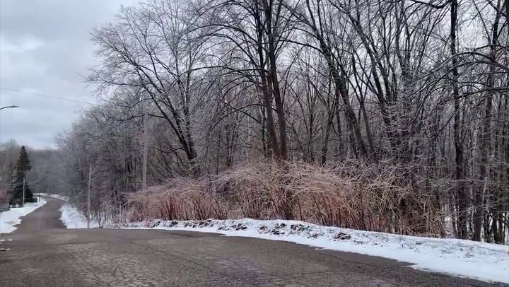 An ice covered tree lined rural road in Arnprior, Ontario