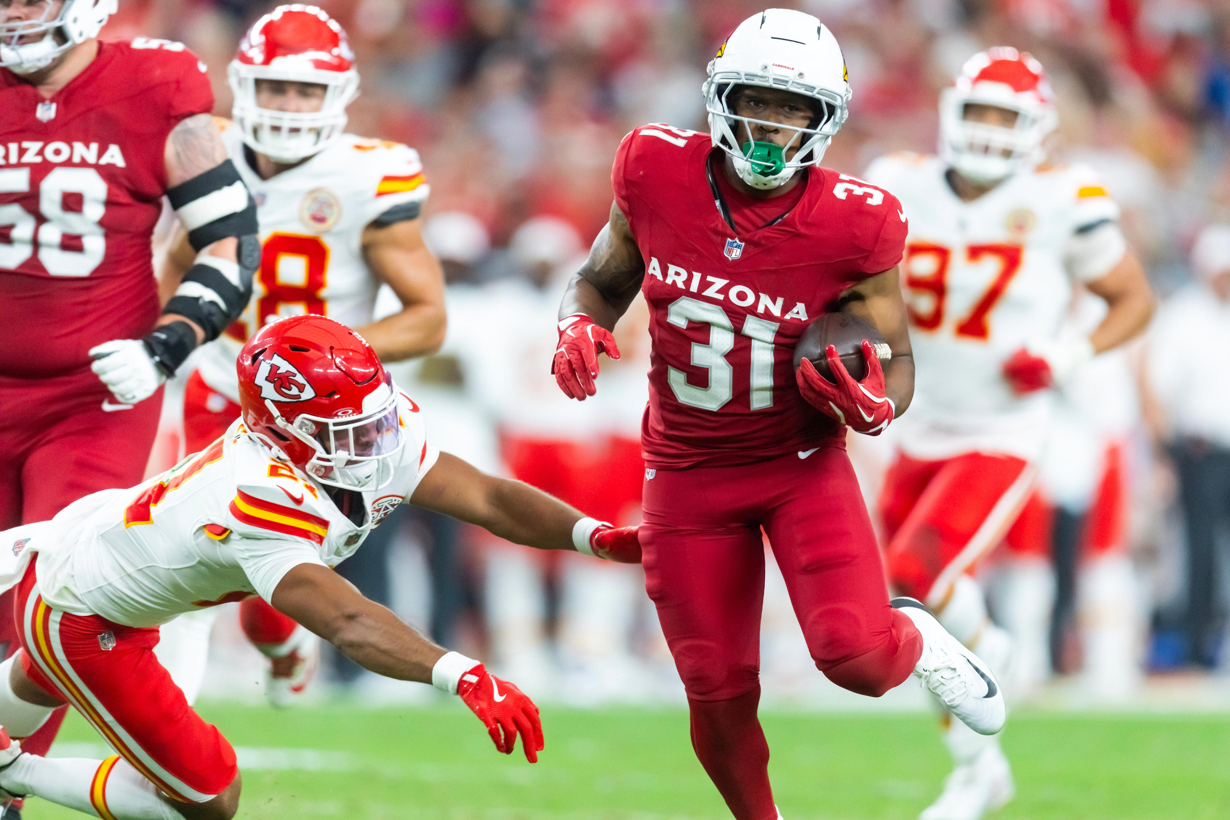 Aug 9, 2025; Glendale, Arizona, USA; Arizona Cardinals running back Emari Demercado (31) runs for a touchdown against the Kansas City Chiefs during a preseason NFL game at State Farm Stadium. Mandatory Credit: Mark J. Rebilas-Imagn Images