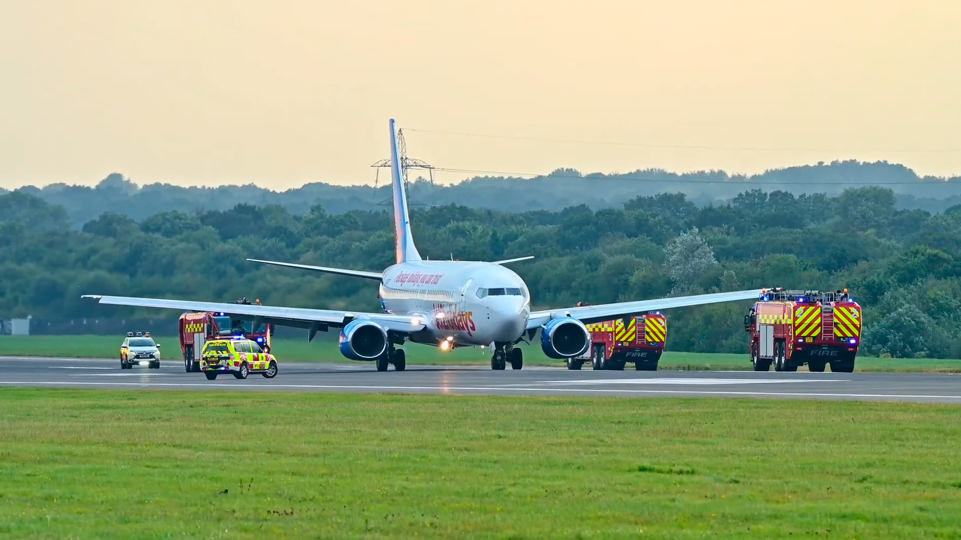 Emergency landing as fire trucks line the runway