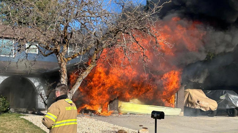 Photos: Garage fire spreads to home in Sandy neighborhood