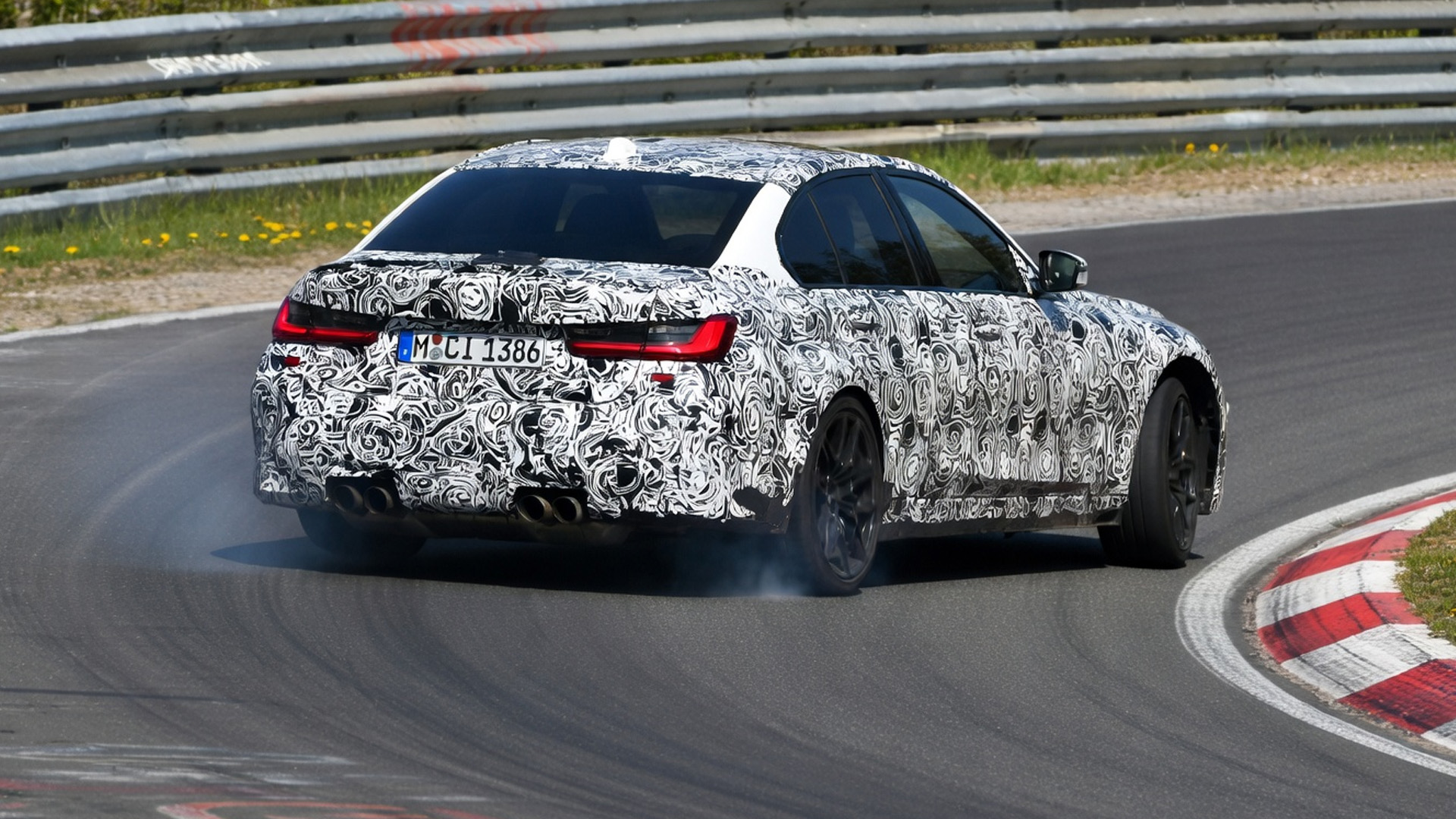 Camouflaged BMW prototype pushes limits on Nürburgring corner