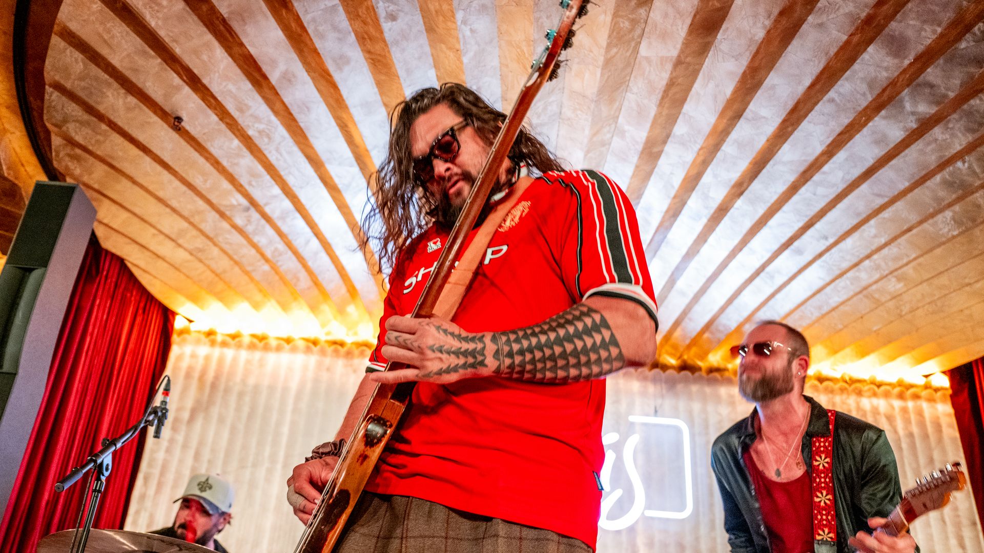 Jason Momoa’s surprise band moment alongside Adria Arjona