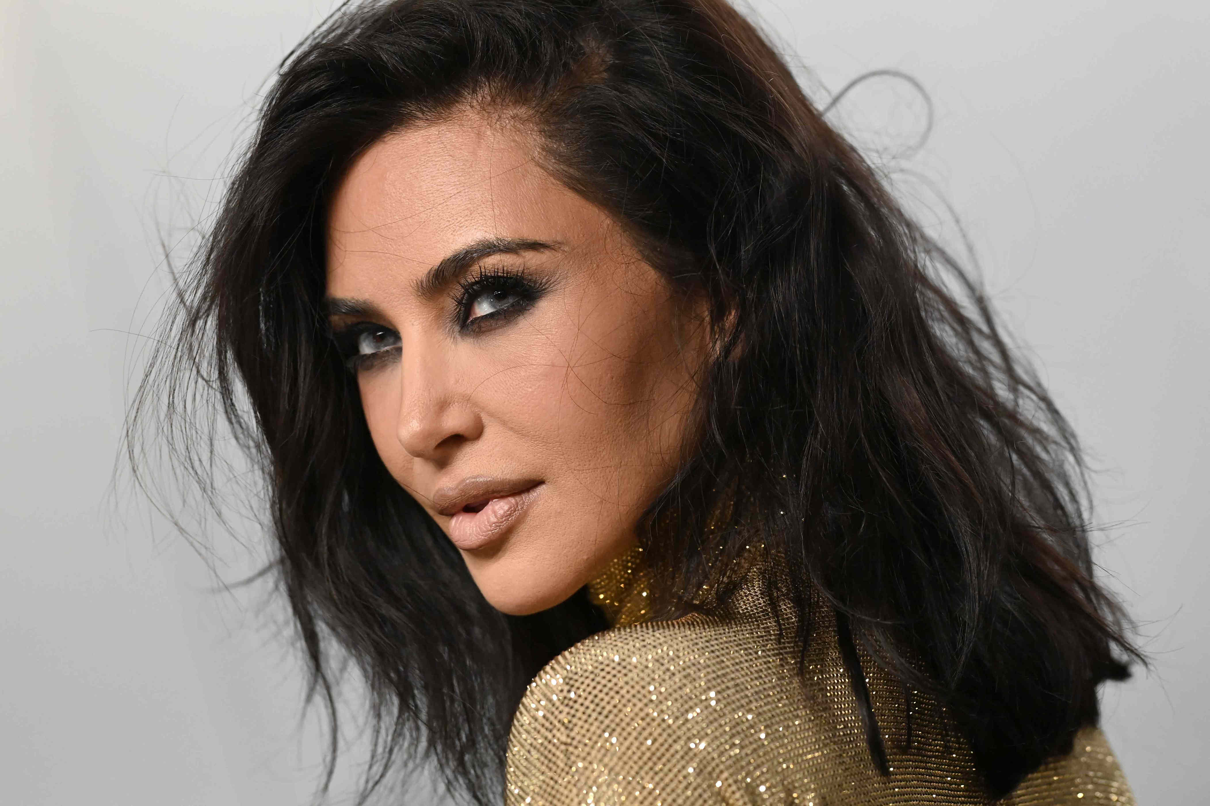 Kim Kardashian cuts her hair even shorter, debuting the transformation in a 32-year-old dress dripping in beads