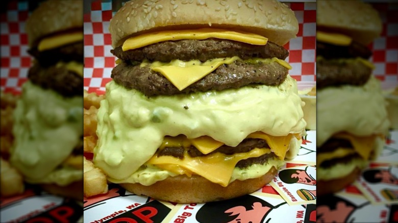 Burger with multiple patties, cheese, and sauce on Big Tom stickers