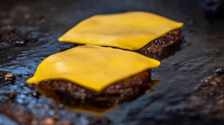 Basic burger with cheese and bacon on red comic background