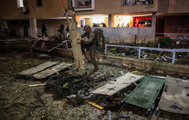 An Israeli soldier prepares stretchers at the impact site after Iranian missile barrages struck residential buildings in Arad, amid the U.S.-Israel conflict with Iran, in southern Israel March 22, 2026. REUTERS/Ilan Assayag