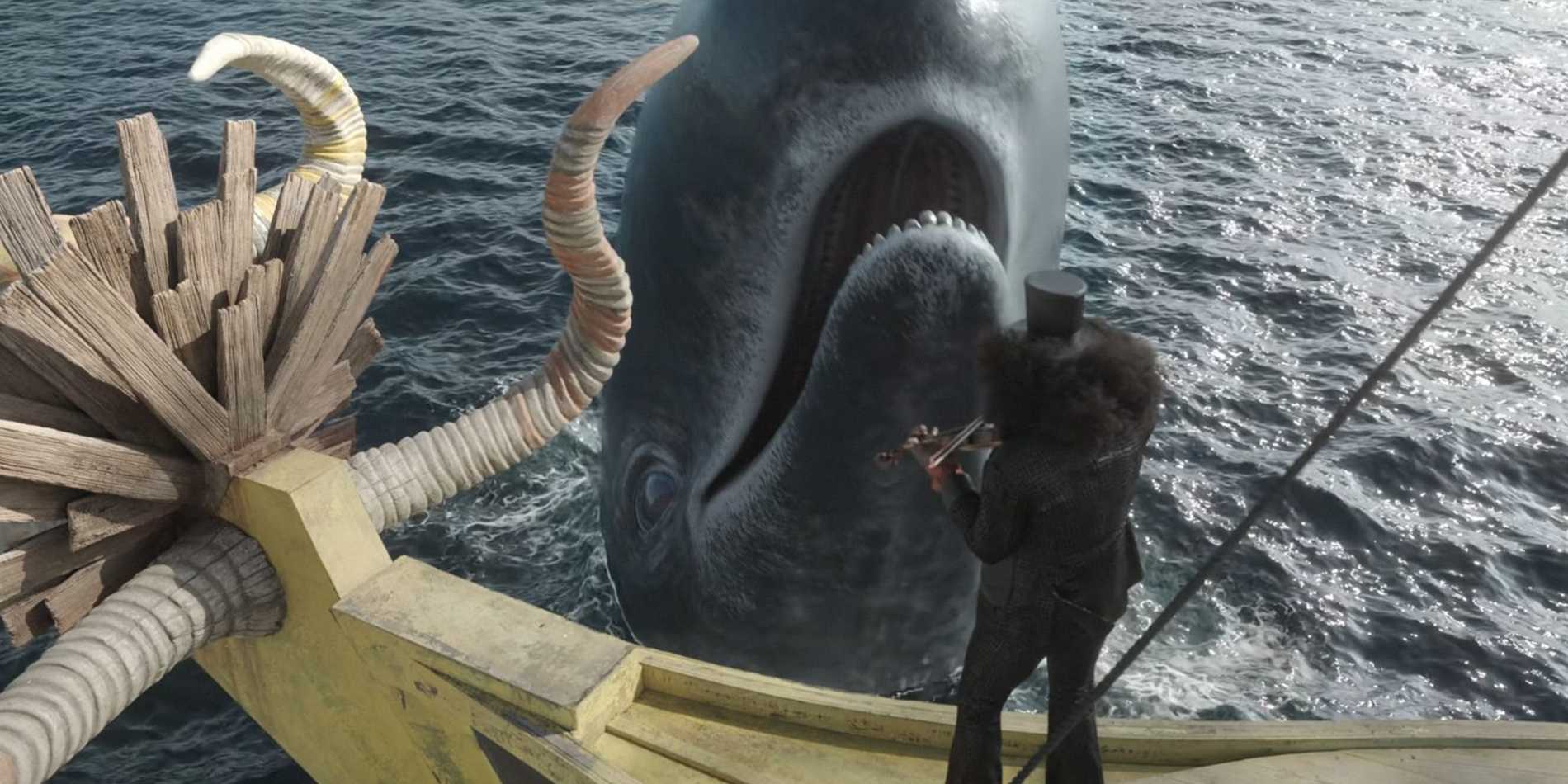 Image from Netflix's One Piece Live Action Season 2 shows Brook with his afro and top hat playing violin while standing on his boat with the whale laboon smiling in front of him.
