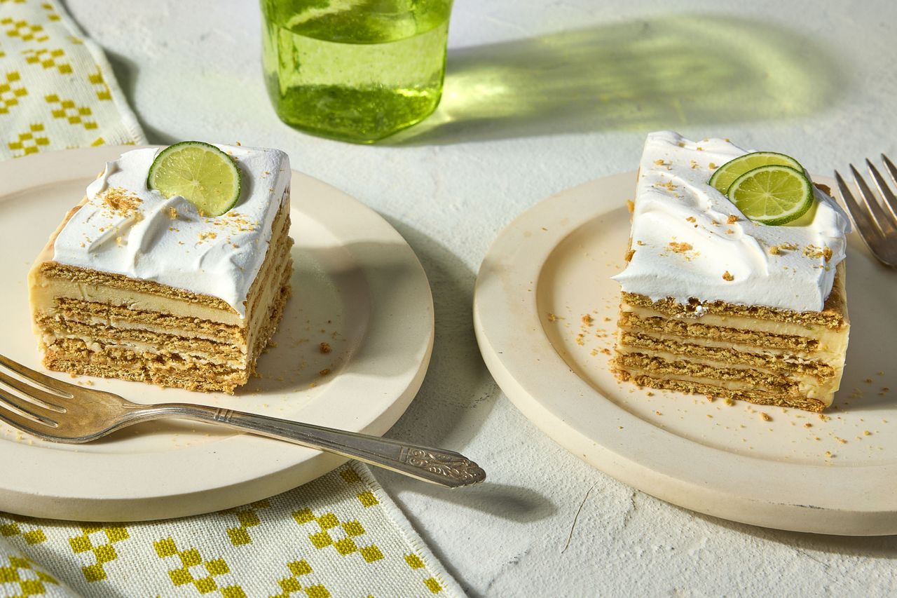 Key lime icebox cake served on two places topped with lime wedges