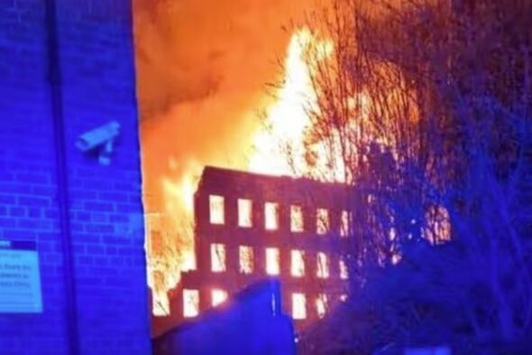 Huge fire rips through historic building in UK town as homes evacuated ...