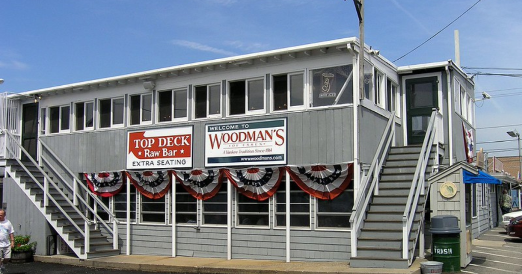 An exterior view of Woodman's Seafood restaurant in Essex, Massachusetts. The building is decorated in patriotic bunting.