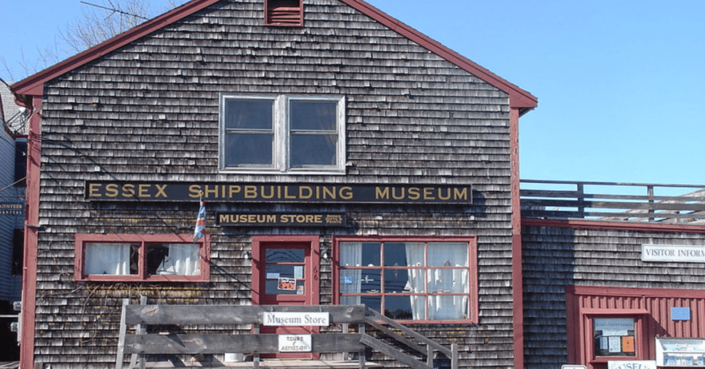 The exterior of the brown, shingled Essex Shipbuilding Museum in Essex, Massachusetts.
