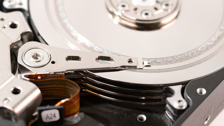 A close up of physical damage to the platter of a hard drive
