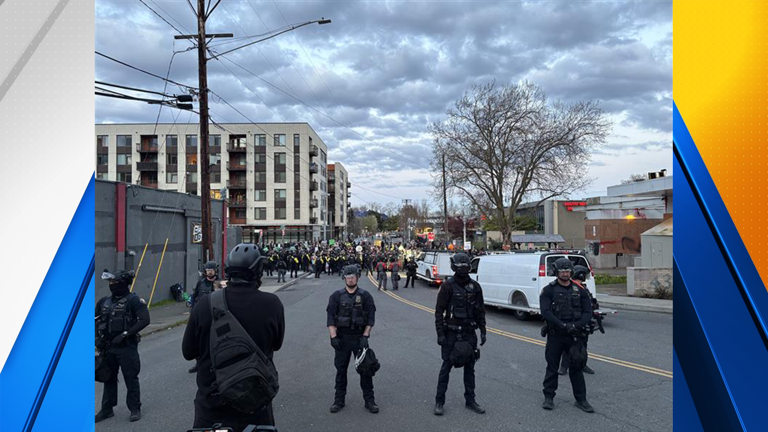 Protesters break through gates at Portland ICE facility, burn flags on ...