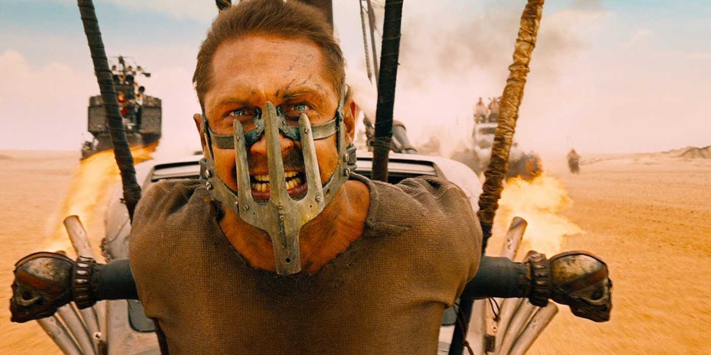 Tom Hardy as Max Rockatansky is strapped to a car in Mad Max: Fury Road.