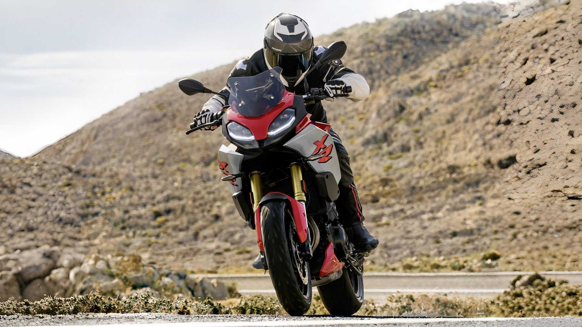 2025 BMW F 900 XR accelerating front third quarter view