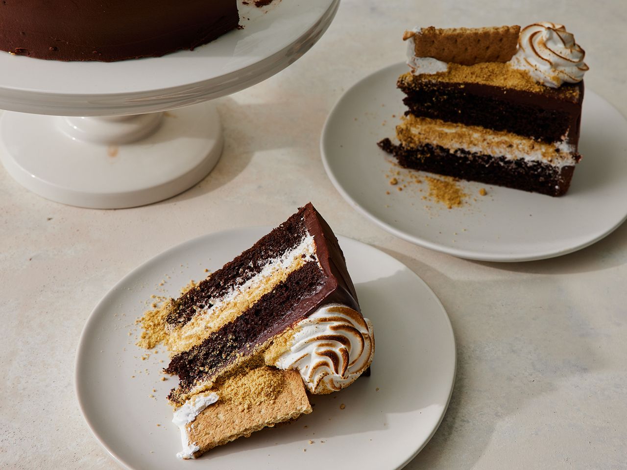 high angle looking down at two slices of S'mores cake on a plate