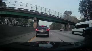 Red car crashes into concrete barrier