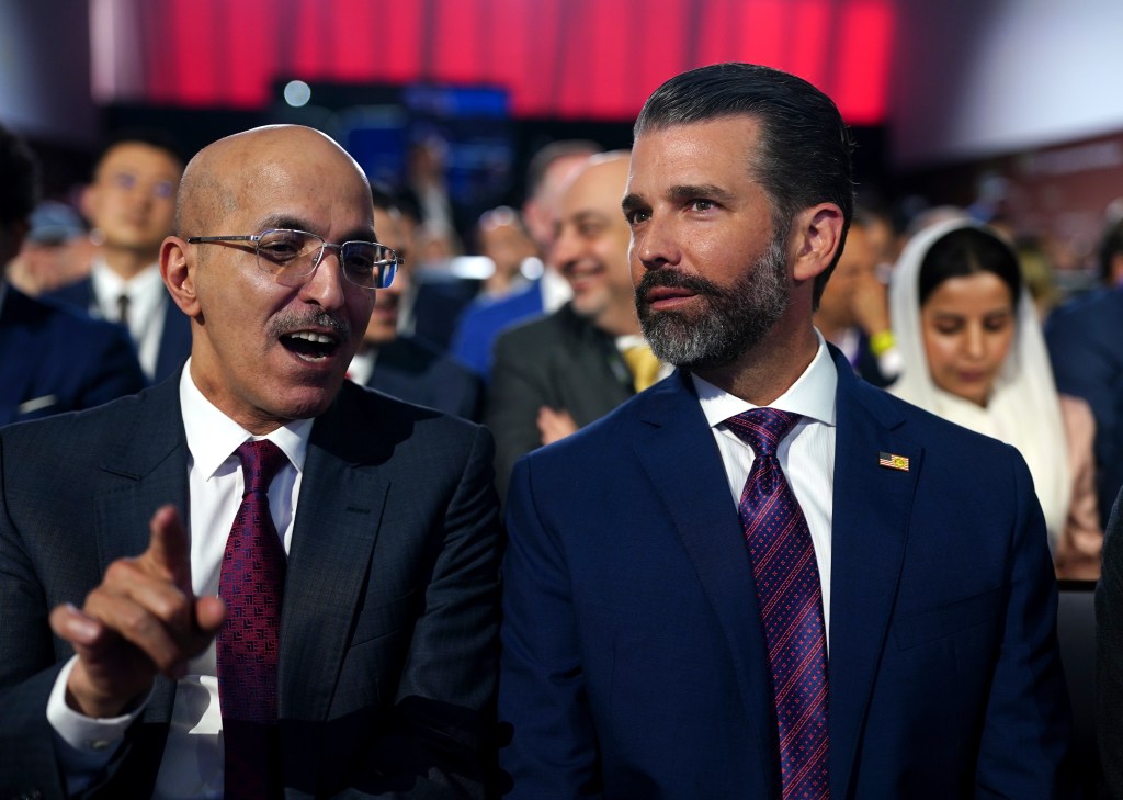 Donald Trump Jr. (right) looks on before his father speaks at the FII PRIORITY Summit. Getty Images