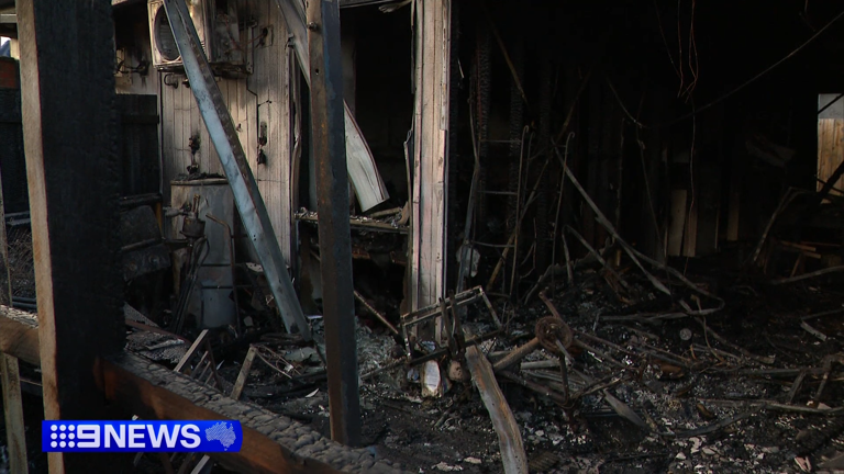 Two men arrested over woman's death in unit complex fire