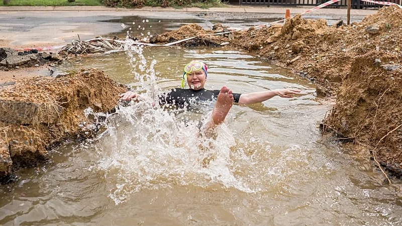 Democratic Alliance (DA) politician Helen Zille swims in a trench on the side of a road in Johannesburg, South Africa on Monday, March 30, 2026 (Photo courtesy of DA Gauteng X
