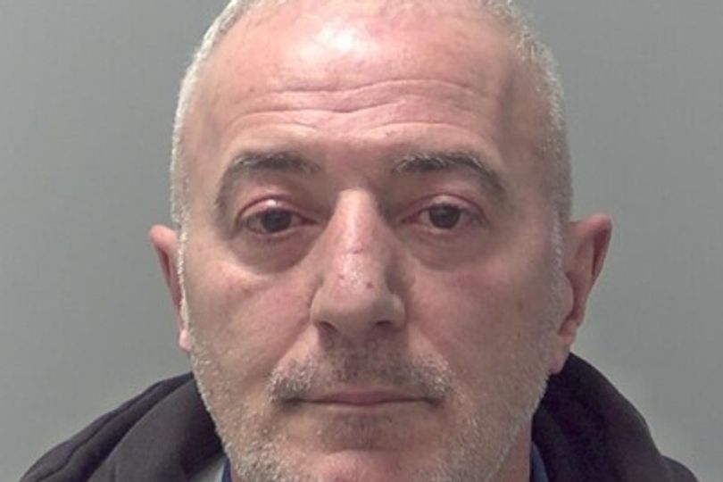 Man tried to evade police by reversing as officer held onto car