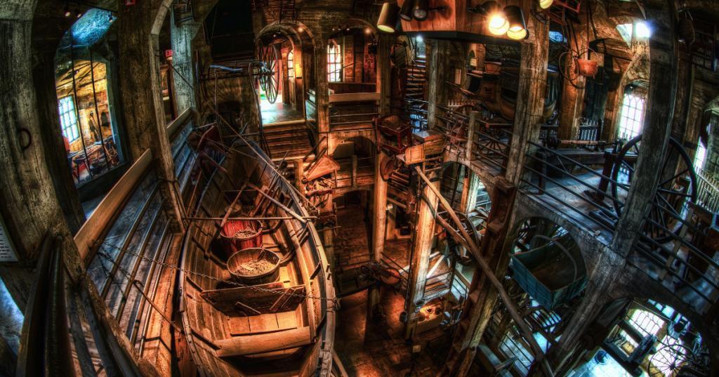 The vaulted interior of Mercer Museum in Doylestown, PA, featuring early American tools and a hanging whaleboat.