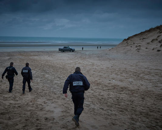 French police patrol the beach of Wimereux searching for people attempting to cross to the UK. Photograph: Kiran Ridley/Getty Images