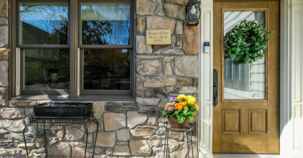Stone exterior and wooden front door of the historic Warner H. Fry Stove Shop Airbnb in Doylestown, Pennsylvania.