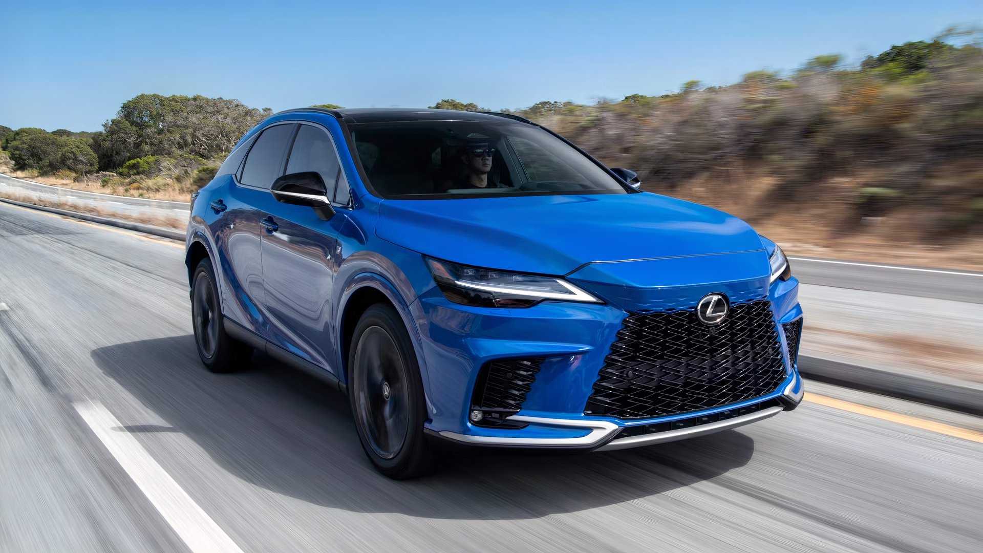 Front 3/4 shot of a blue 2026 Lexus RX driving on a road