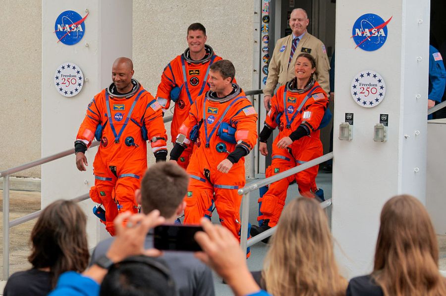 CAPE CANAVERAL, FLORIDA – APRIL 01: (L-R) Pilot Victor Glover, mission specialist Jeremy Hansen of CSA (Canadian Space Agency), commander Reid Wiseman and mission specialist Christina Koch walk out of the Neil A. Armstrong Operations and Checkout Building ahead of the launch of the Artemis II at NASA’s Kennedy Space Center on April 01, 2026 in in Cape Canaveral, Florida. The 322-foot-tall Artemis II Space Launch System rocket and Orion spacecraft will take the astronauts around the moon and back, 230,000 miles out into space and the farthest any human has ever traveled from Earth. (Photo by Chip Somodevilla/Getty Images)