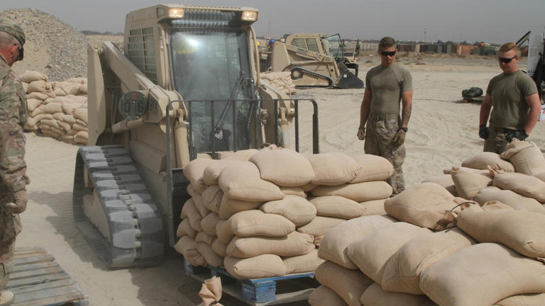 A group of soldiers fill sandbags at Camp Arifjan, Kuwait, in April 2020. The Department of Defense has requested proposals for permanent prefabricated bunkers for use in its Middle East bases. (US Army/Sgt. Andrew Valenza)