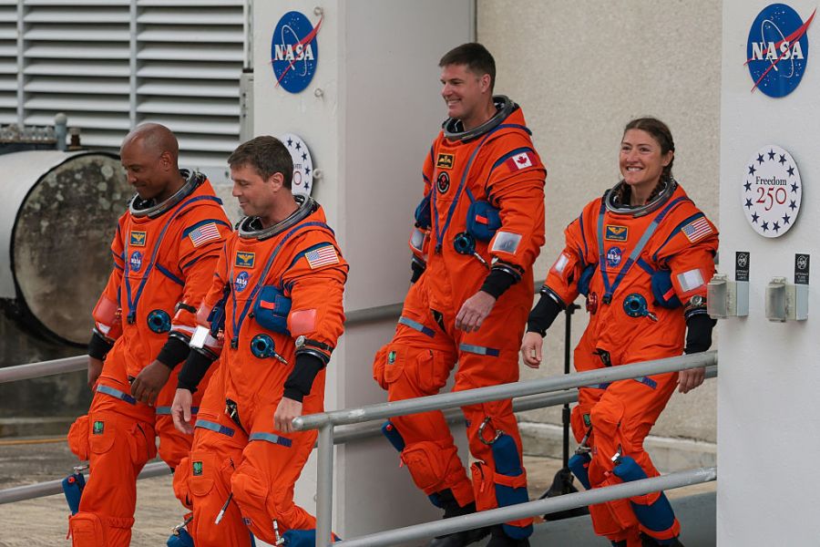 CAPE CANAVERAL, FLORIDA – APRIL 01: (L-R) Pilot Victor Glover, commander Reid Wiseman, mission specialist Jeremy Hansen of CSA (Canadian Space Agency) and mission specialist Christina Koch walk out of the Neil A. Armstrong Operations and Checkout Building ahead of the launch of the Artemis II at NASA’s Kennedy Space Center on April 01, 2026 in in Cape Canaveral, Florida. The 322-foot-tall Artemis II Space Launch System rocket and Orion spacecraft will take the astronauts around the moon and back, 230,000 miles out into space and the farthest any human has ever traveled from Earth. (Photo by Joe Raedle/Getty Images)