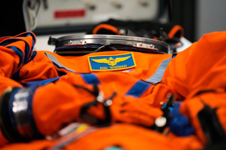 A suit that Artemis II Commander Reid Wiseman uses for training lies on a table in the Orion Crew Survival Systems lab at Johnson Space Center on Thursday, July 24, 2025, in Houston. (AP Photo/Ashley Landis)