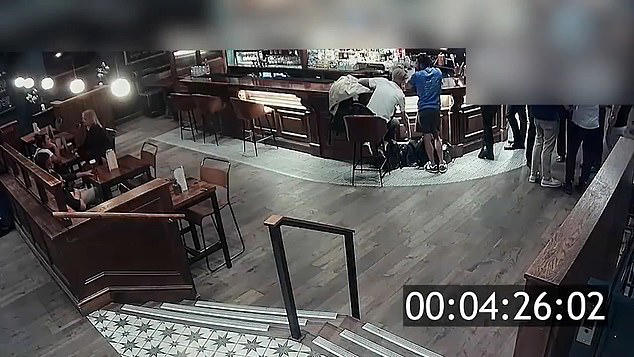 Moment two brazen thieves calmly go through pubgoers' bags as they ...