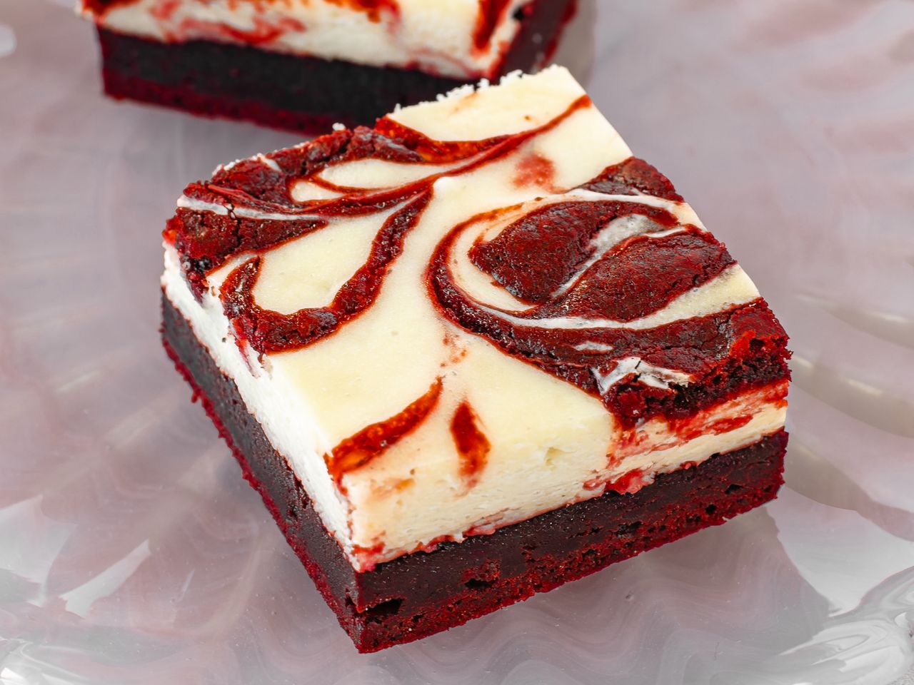 Red velvet cheesecake brownie with a marbled cream cheese and chocolate swirl topping