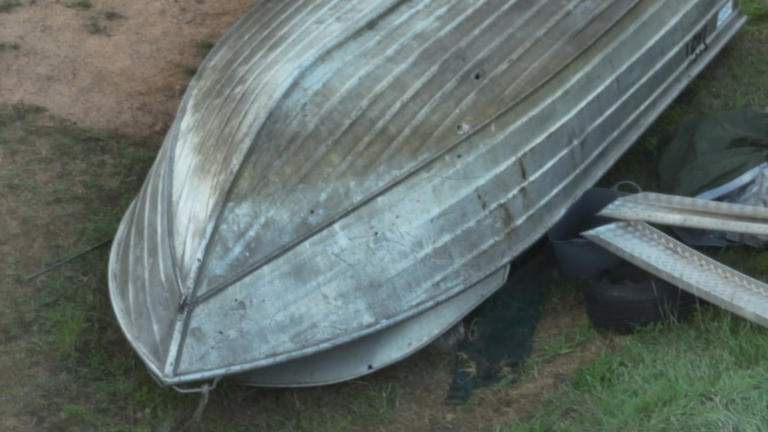 Several bullet holes pierced an overturned boat near the shipping container where Dezi Freeman was discovered in.