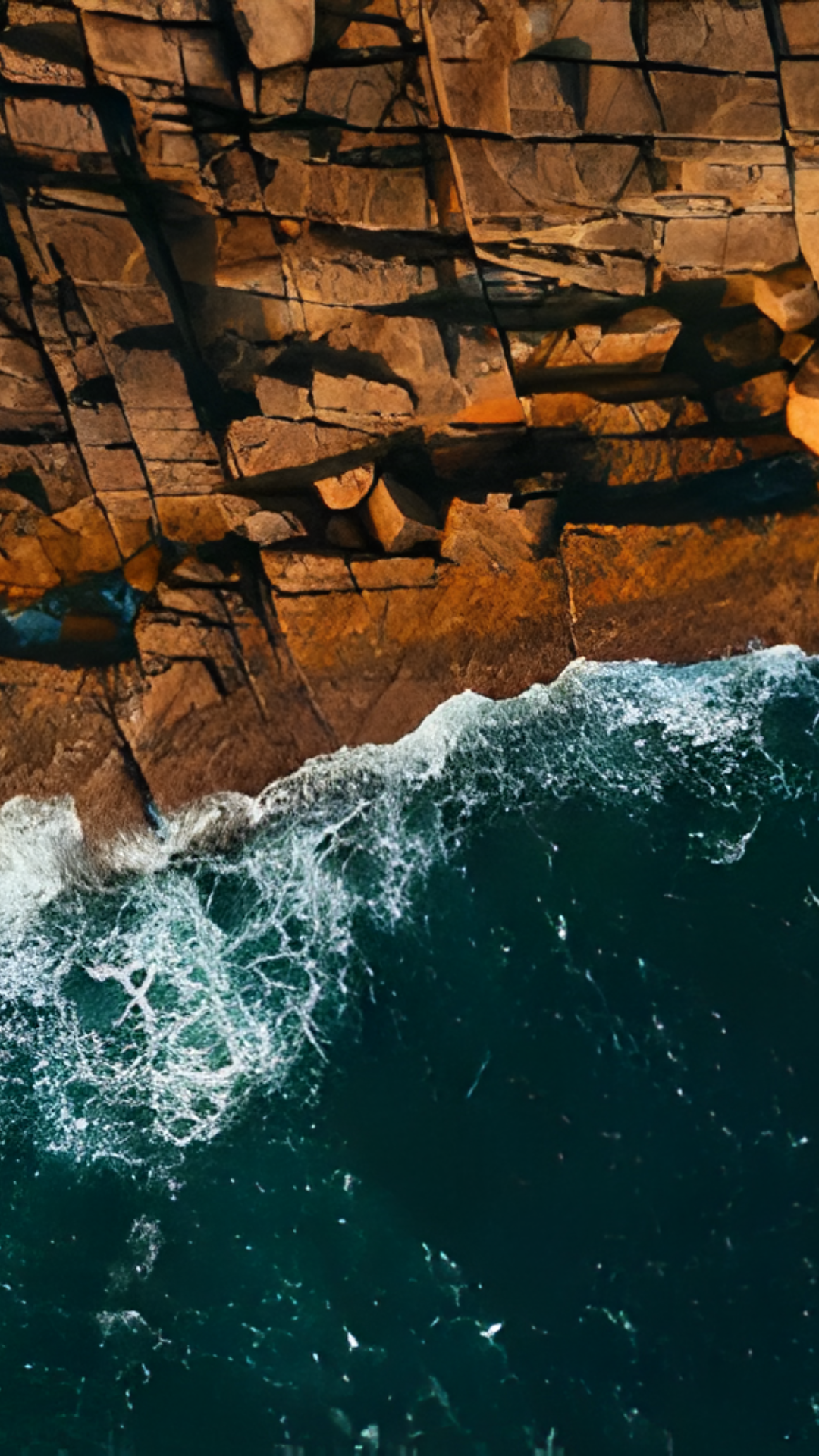 Aerial coastal journey: Stunning views of rocky shores and scenic towns