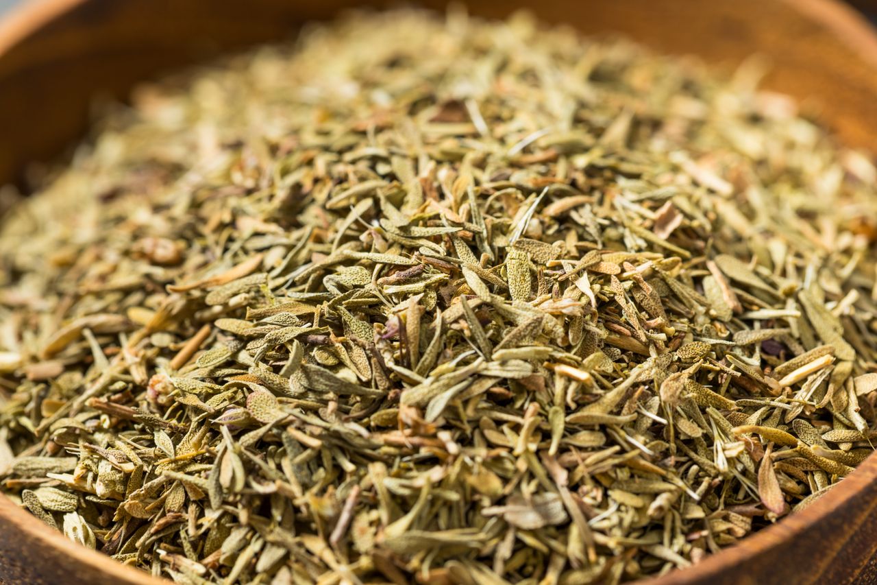 Dried herbs in a wooden bowl