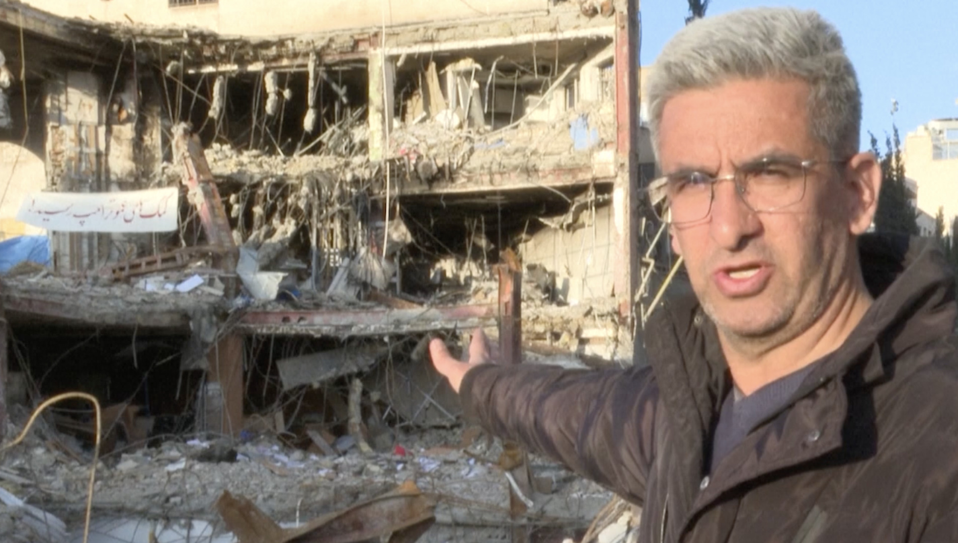 Brothers search rubble for missing sibling under Tehran rubble after strike