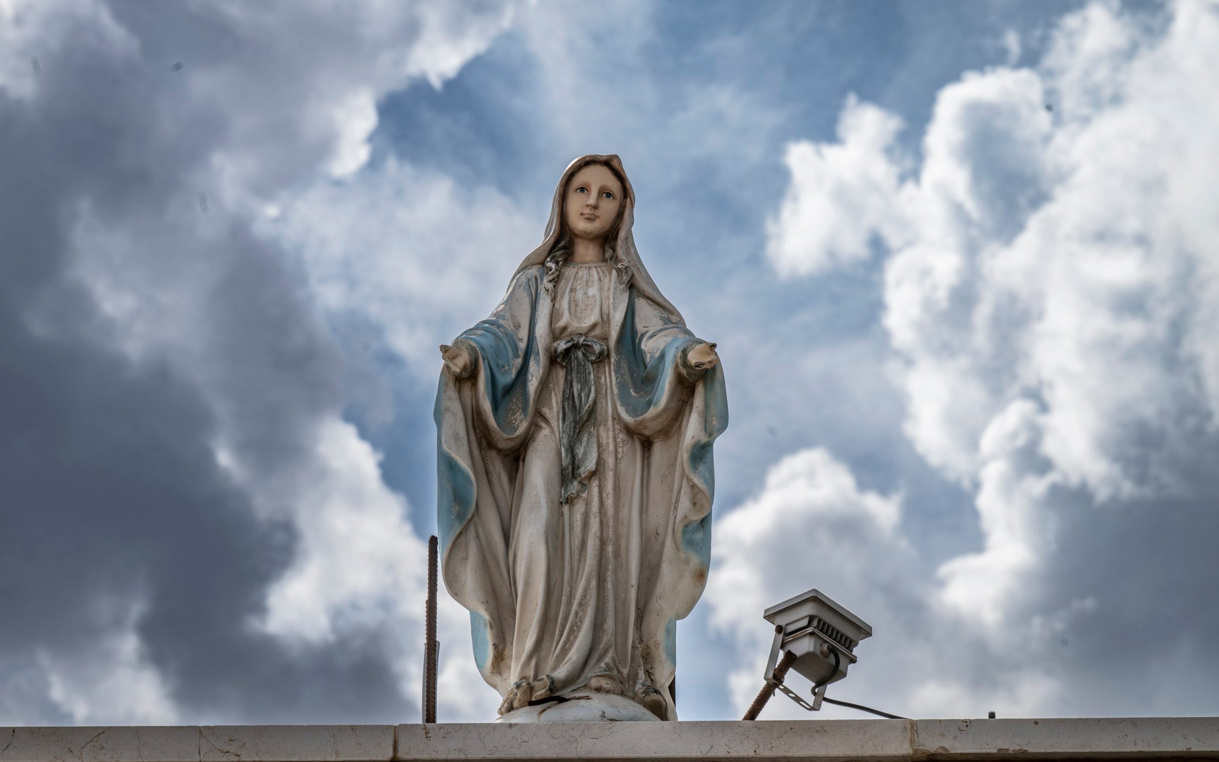 A statue of the Holy Mary stands on a house in Ras Baalbek - Simon Townsley