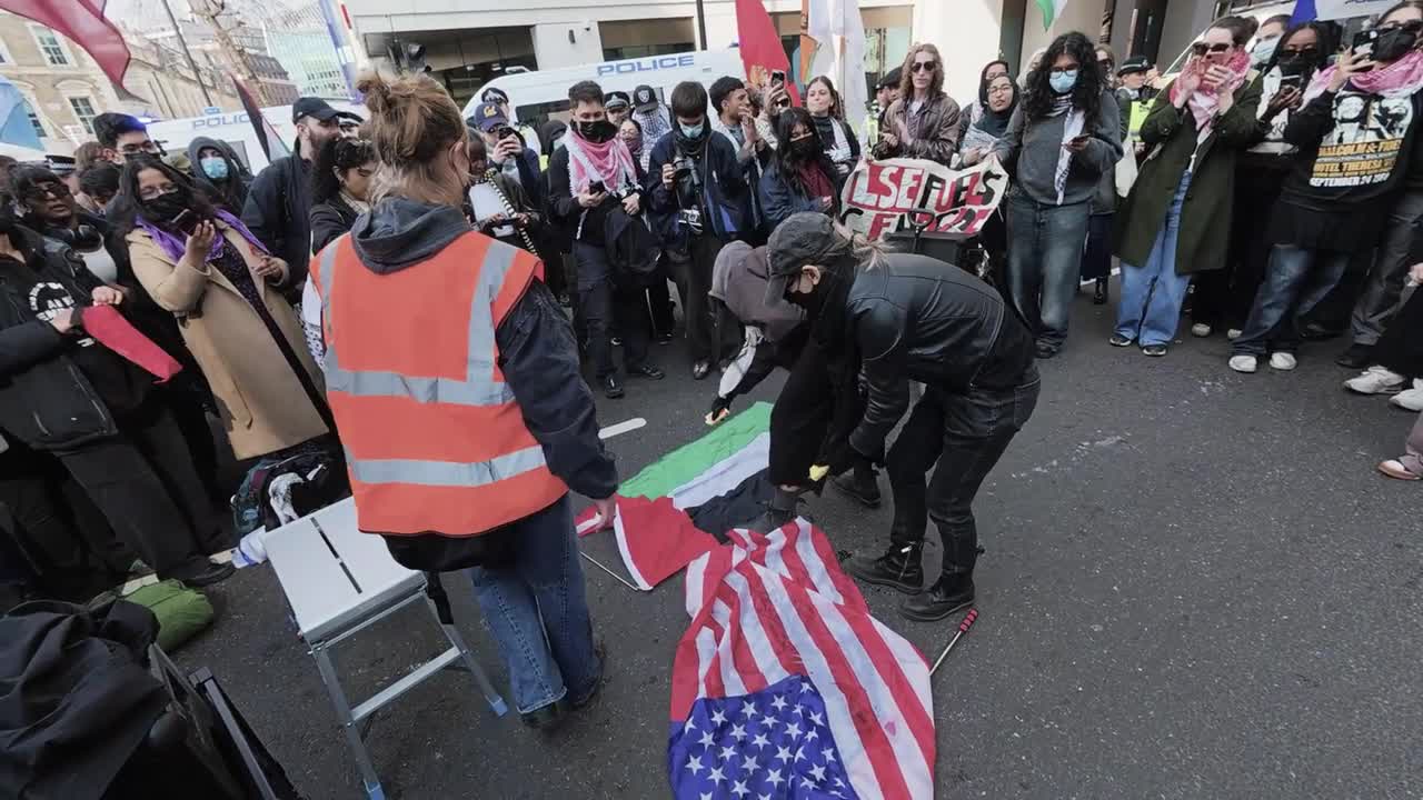 US and UAE flags set on fire during anti-war protest outside American ...