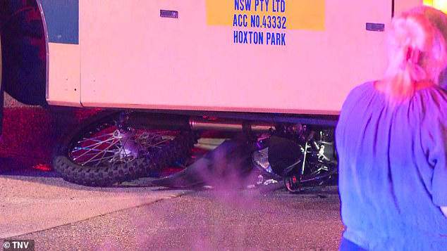 The bike was wedged under the front of the bus 